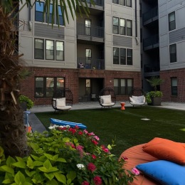 a courtyard with chairs and trees