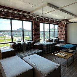a clubroom with tables and couches