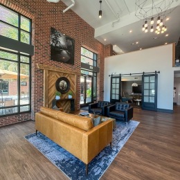 a clubroom with a tv, couch, table and chairs