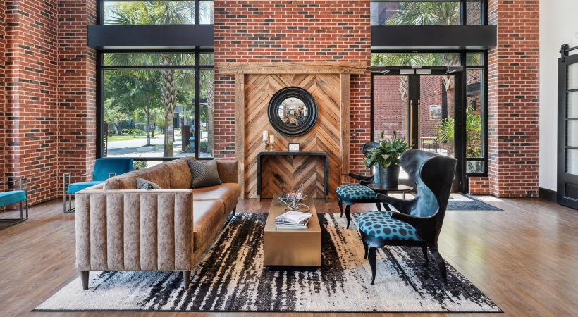 a clubroom with a couch, table and chairs