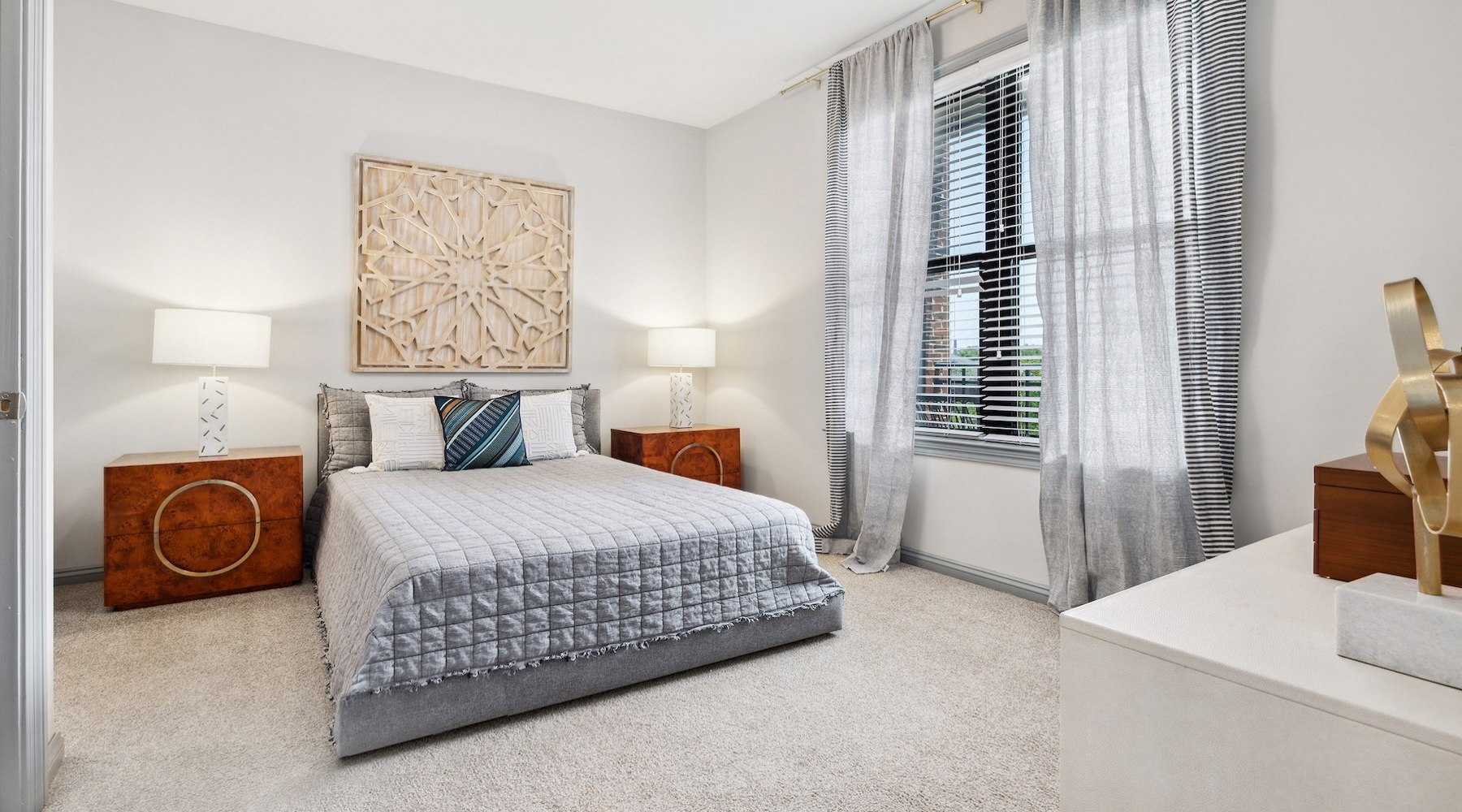 a bedroom with a bed and two nightstands