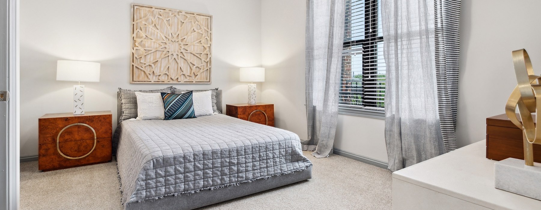 a bedroom with a bed and two nightstands