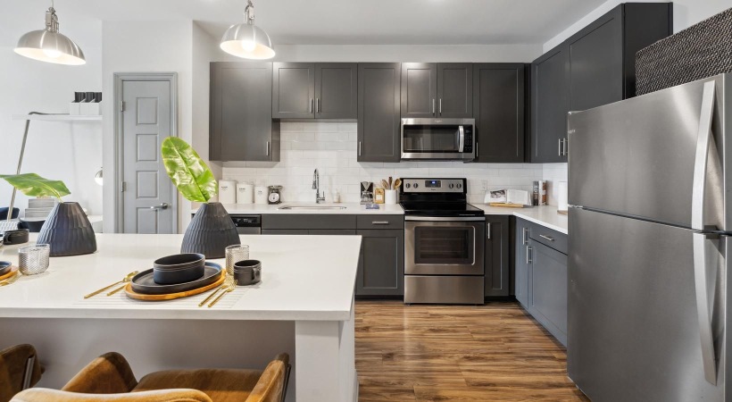 a kitchen with black cabinets